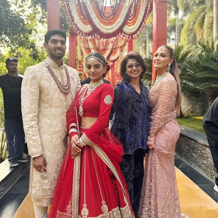 Group photo at a wedding event featuring guests in traditional attire, associated with Jennifer Lopez's risqué performance.