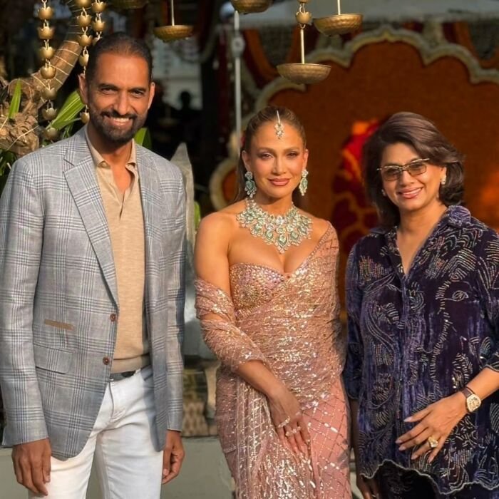 Jennifer Lopez posing in a glittering outfit during her risqué performance at a billionaire's wedding event.