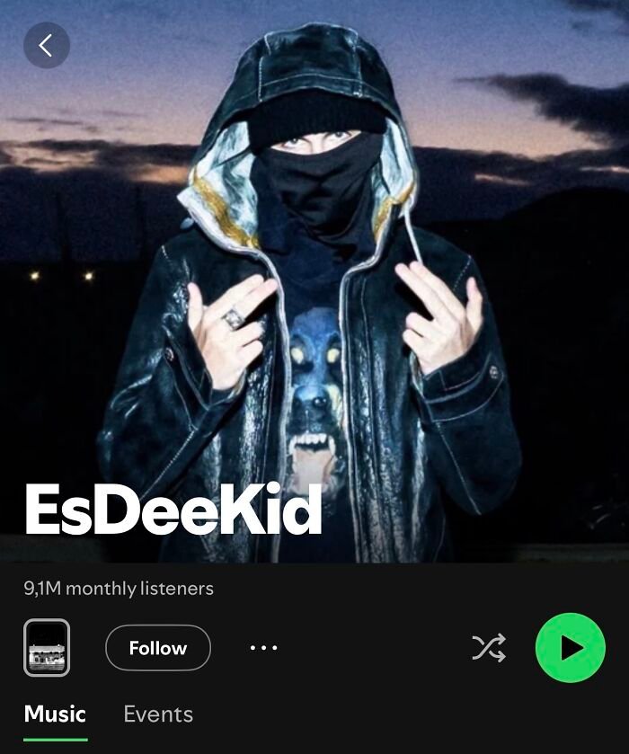 Masked rapper EsDeeKid wearing a black leather jacket and hood, linked to Timoth&eacute;e Chalamet by fans in viral theory.