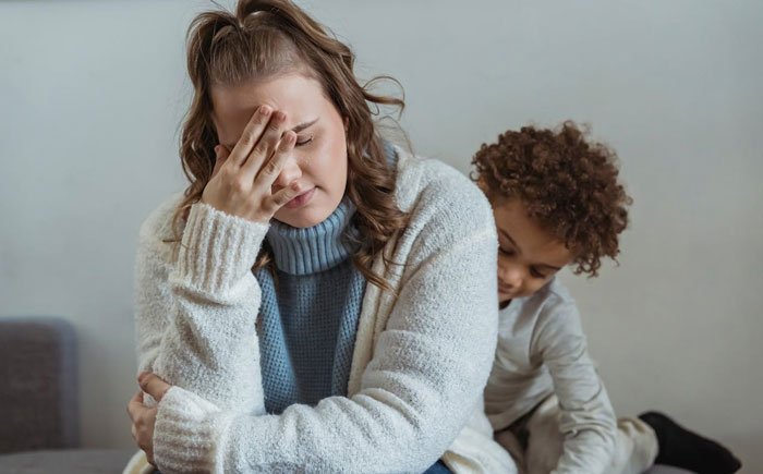 Stressed mom overwhelmed by how her kids act, seeking solutions as behavior starts to spit and cause tension at home.