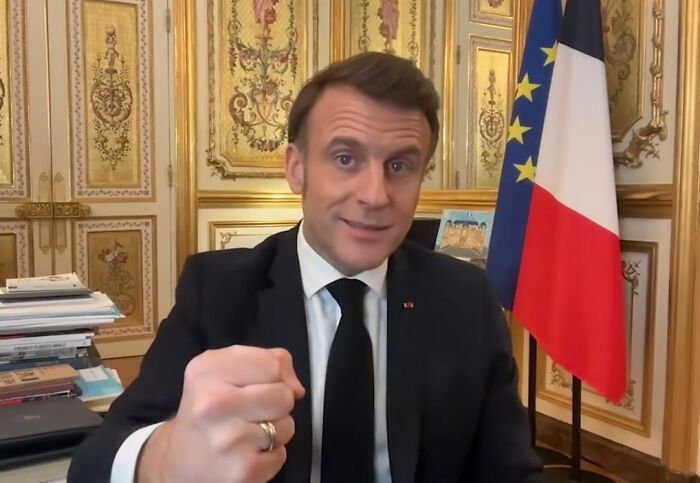 French soldier’s odd behavior behind Macron in ornate room with French flag sparks France is boiling conspiracy theories.