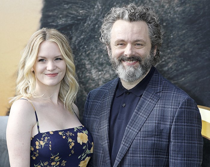 Michael Sheen and a woman smiling together at an event, highlighting Michael Sheen's dating history.