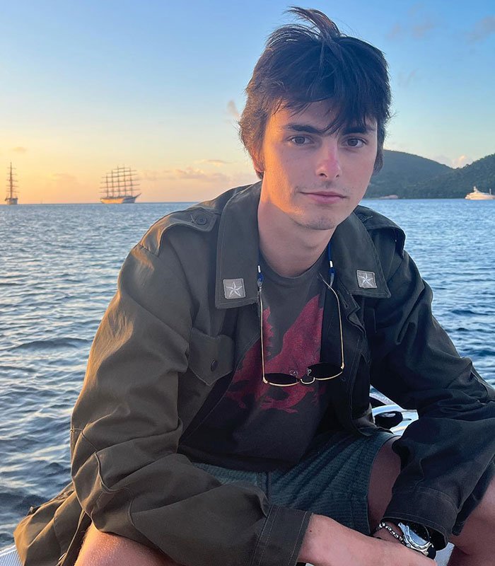 Young man sitting by the sea at sunset, related to Scott Jennings hitting back at Michael Douglas and Zeta-Jones debate flop.