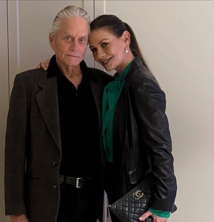 Michael Douglas and Catherine Zeta-Jones posing together, related to nepo baby son’s debate flop controversy.
