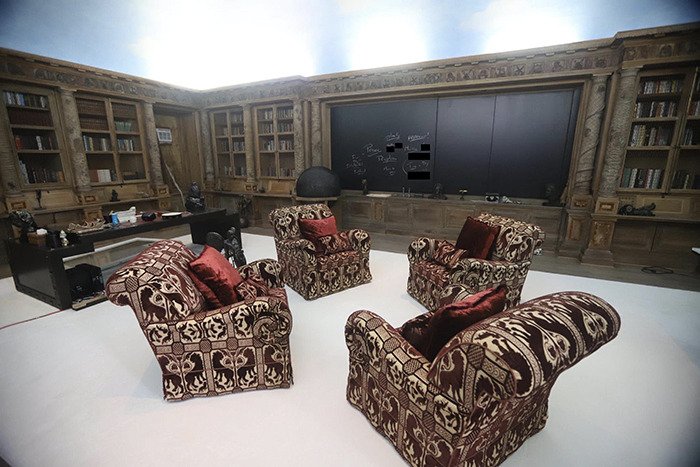 Eerie new images from Epstein’s private island home showing a dimly lit study with patterned armchairs and bookshelves.