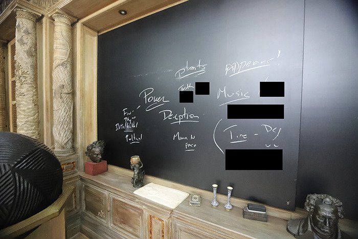 Eerie new images from Epstein’s private island show a blackboard with cryptic writings and sculptures inside the home.