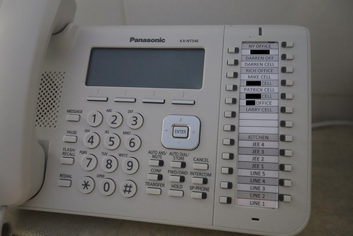 Landline phone with multiple labeled buttons inside Epstein’s private island home, showing eerie new images of the interior.