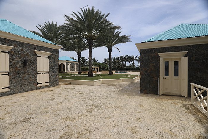 Eerie new images from Epstein’s private island home showing stone buildings with blue roofs and tall palm trees outside