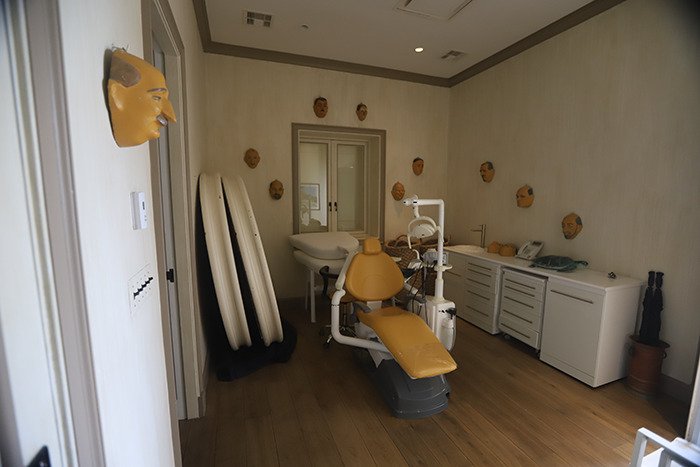 Dental chair and eerie face masks on walls in Epstein’s private island home, revealing unsettling interior details.