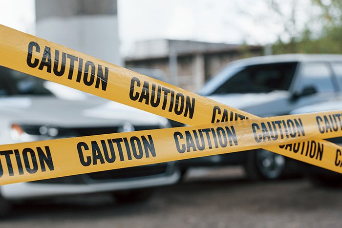 Yellow caution tape blocking off a street scene related to woman's chilling 911 call after attacking boyfriend.