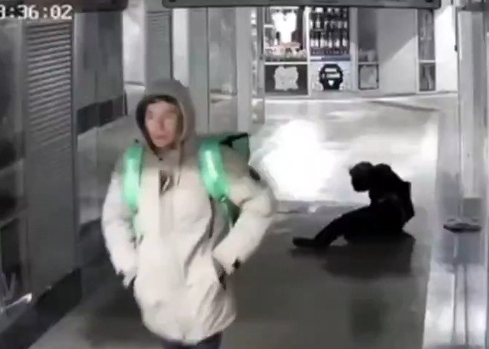 Delivery man caught on CCTV randomly kicking woman in the head in a public hallway incident.