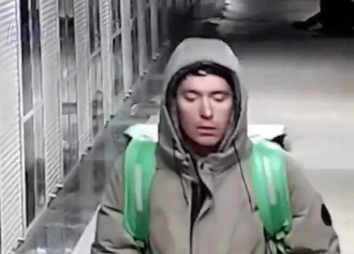 Delivery man in hoodie and backpack caught on CCTV in disturbing act, labeled as terrible psychopath during random attack incident.