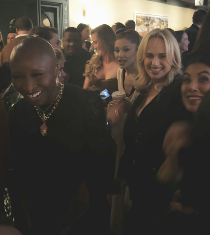 Rebel Wilson and Ariana Grande at a crowded event with people noticing a bizarre detail in the shared photo.