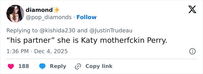 Justin Trudeau and Katy Perry at a formal meeting with Japan's ex-PM, capturing a classy diplomatic moment.