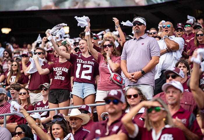 Crowd at a Texas A&M game, showing fans cheering in maroon, related to mom of late cheerleader refusing cops' ruling.
