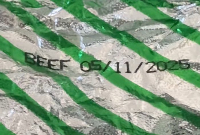 Close-up of an Air Canada passenger meal package showing beef with an expiration date, highlighting airline meal concerns.