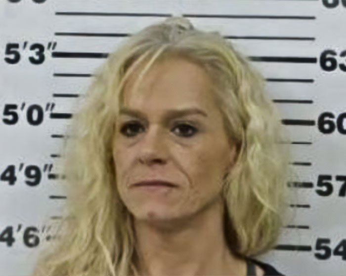 Mugshot of woman involved in incident where mom calls 911 after kids eat her gummies sparking arrest debate.