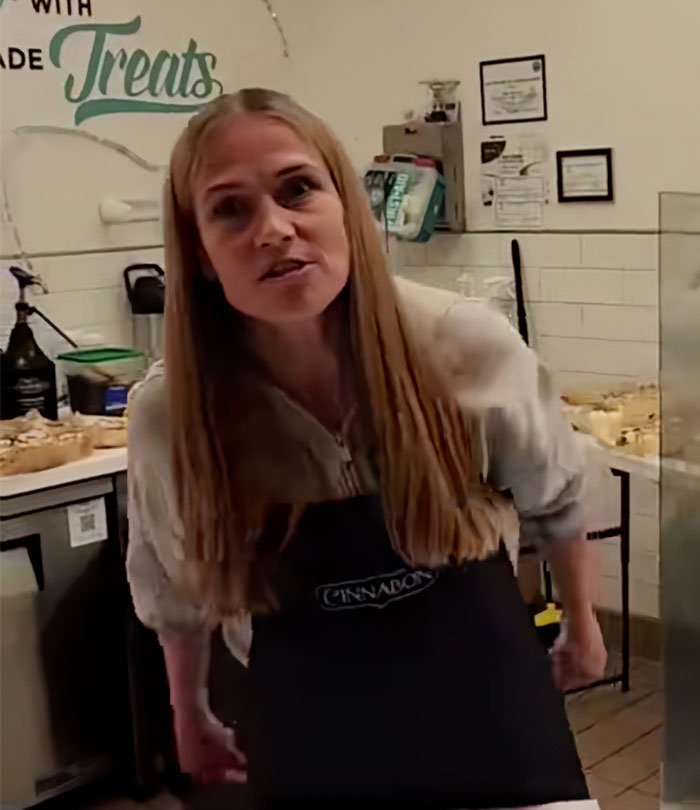 Cinnabon worker in apron inside bakery, involved in viral tirade and linked to criminal past revealed.