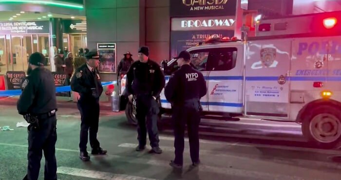 NYPD officers stand near an ambulance at a NYC street scene after a Marvelous Mrs. Maisel actress lost her life crossing the road.