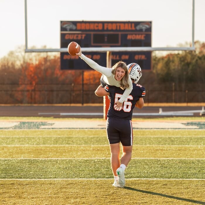 Mother and son in a playful photoshoot on football field, highlighting viral mother-son dating parenting debate.