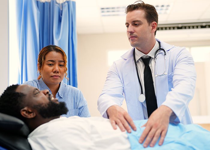 Woman confronts husband in hospital as doctor examines him, highlighting risks to future child&rsquo;s health after exposing his lie.