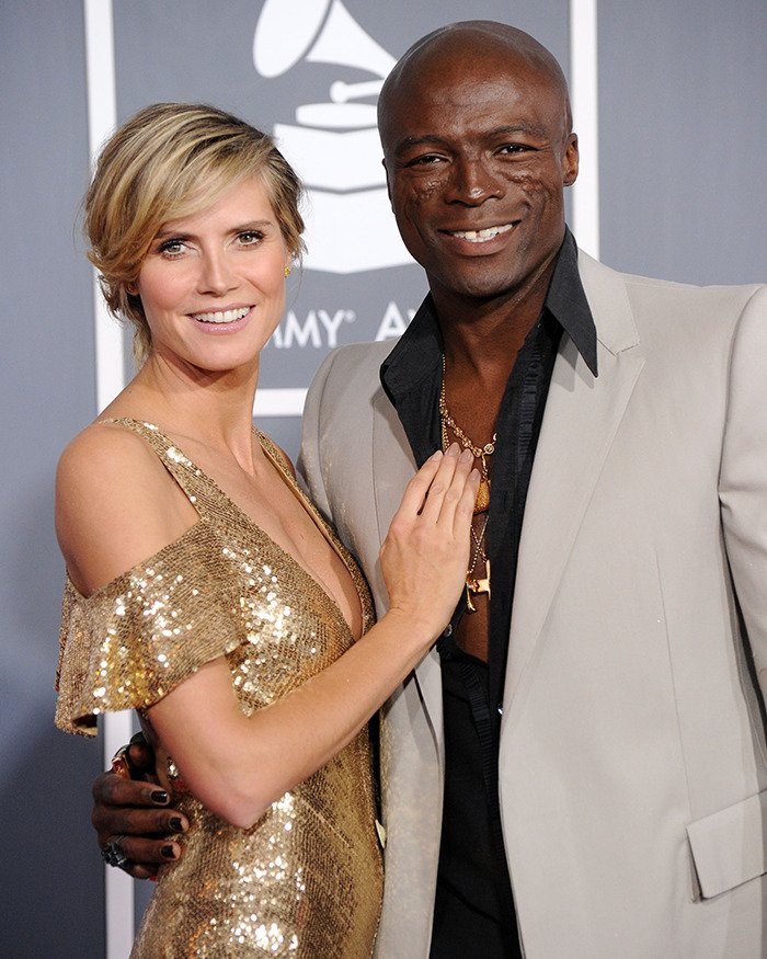 Heidi Klum and a man posing on the red carpet, linked to Heidi Klum sparks outrage Elle cover controversy.