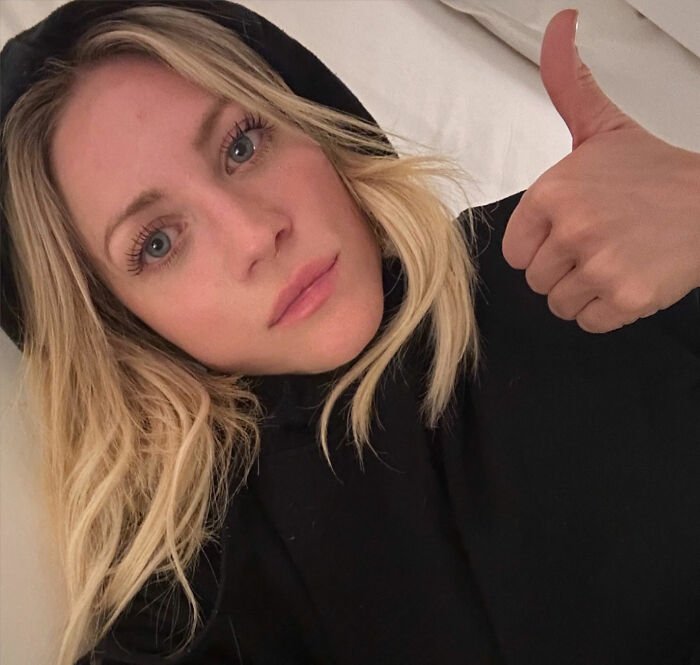 Britanny Snow giving a thumbs up while responding to plastic surgery rumors in a casual selfie.