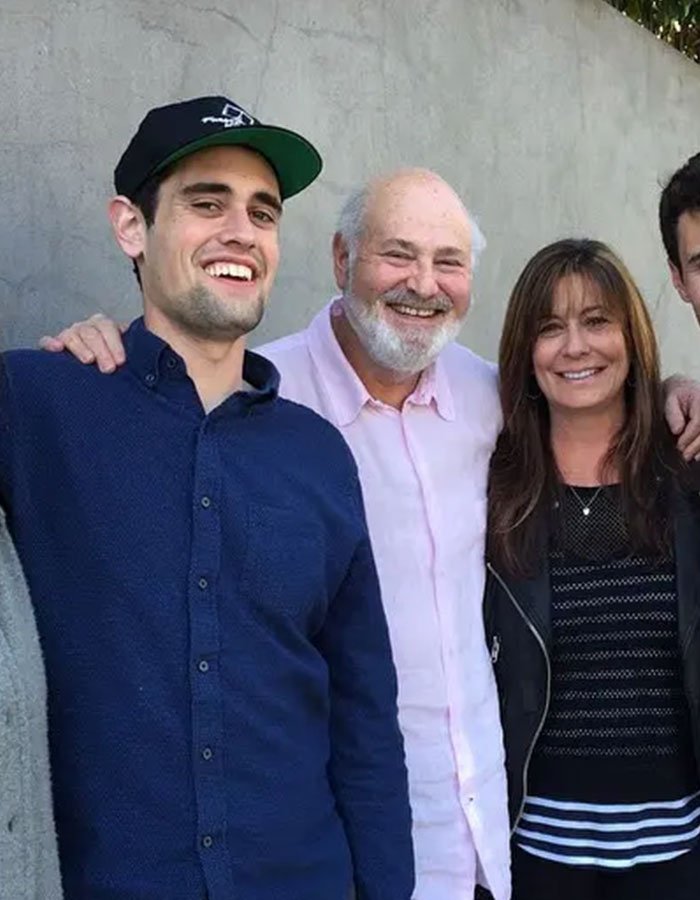 Group of people smiling at an outdoor event, related to Rob Reiner's son and celebrities at Conan O'Brien's party.