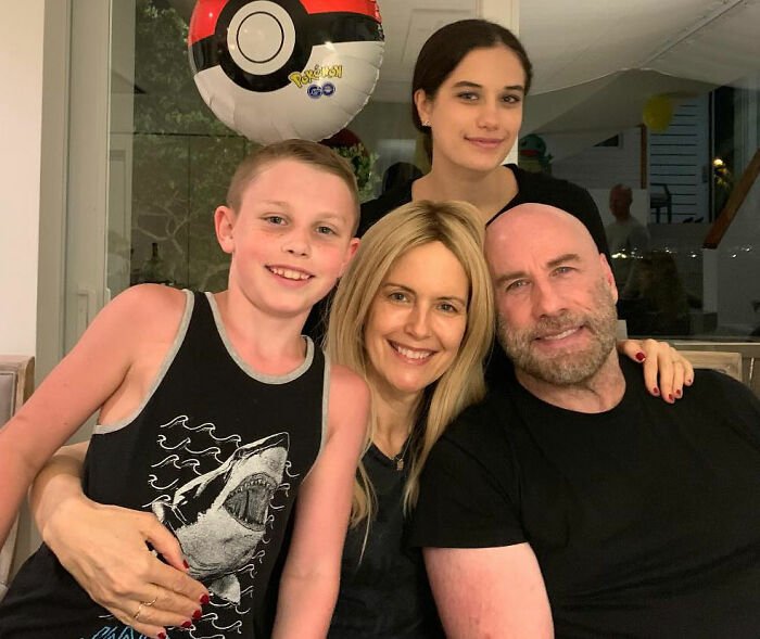 Riley Keough with family smiling indoors, highlighting court docs revealing biological mother link to John Travolta’s son Ben.