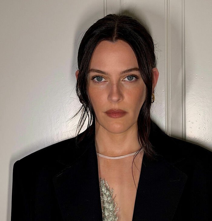 Riley Keough posing in a black blazer, highlighting court docs revealing her as John Travolta’s son Ben’s biological mother.