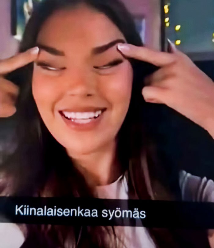 Beauty queen making racist gesture with fingers by eyes, related to Japan government and Finland controversy.