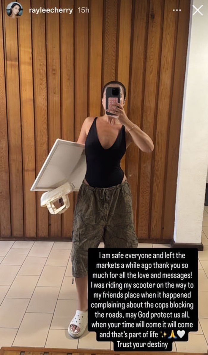 Swimwear model taking mirror selfie in black suit and cargo shorts, sparking outrage with tone deaf posts after Bondi Beach attack.