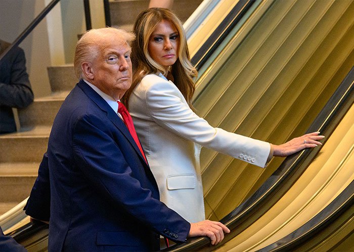 Donald Trump and Melania Trump on an escalator, photographed during a formal event related to Melania Trump's new documentary.