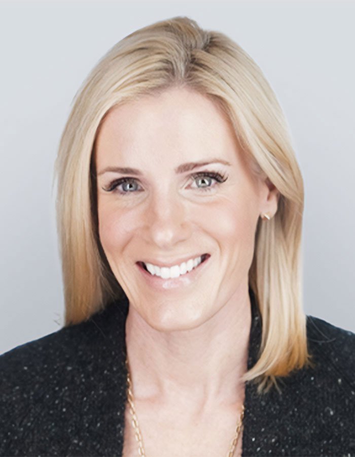 HR executive with blonde hair and a black jacket smiling in a professional headshot, related to hypocrite controversy.