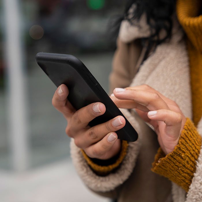Woman angrily holding phone, upset her sister built TikTok fame by lying, family now believes the false story.