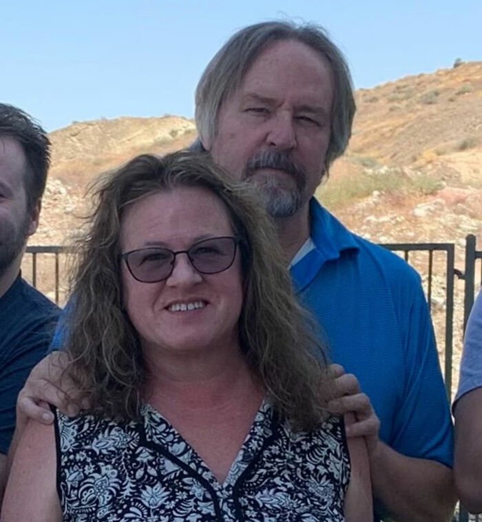 Group of people outdoors with a smiling woman, related to trans Muslim woman’s fate after skipping sentencing news.