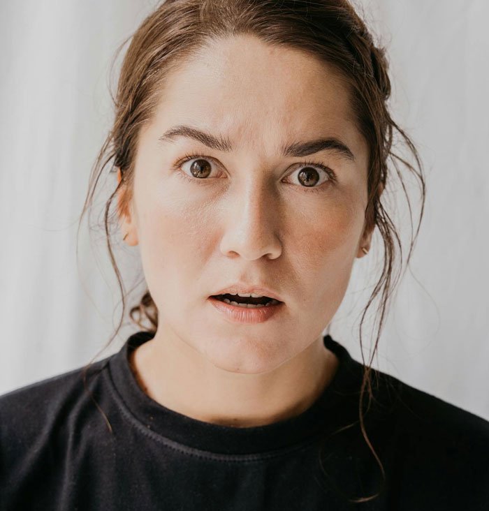 Woman with a shocked expression, reacting to the complicated situation involving affair partner&rsquo;s baby and family relations.