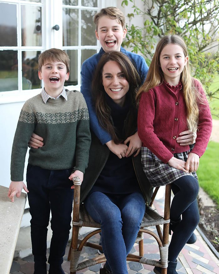 Family smiling together outdoors in cozy sweaters, sparking discussion about Prince Harry and Meghan Markle holiday snap manipulation.