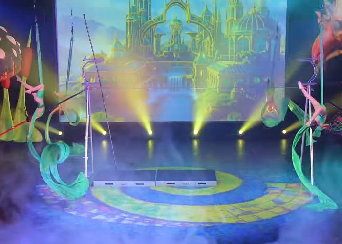 Performance from Wizard Of Oz show with acrobats and vibrant stage lights causing audience outrage and walkouts