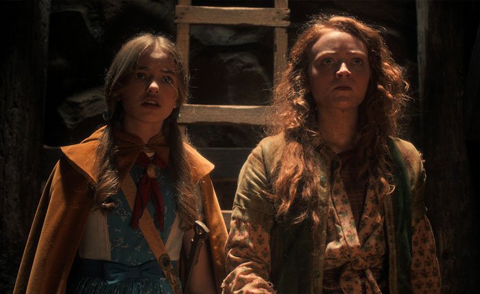 Two female characters from Stranger Things 5 looking tense in a dimly lit, rustic setting, highlighting comically bad scenes.
