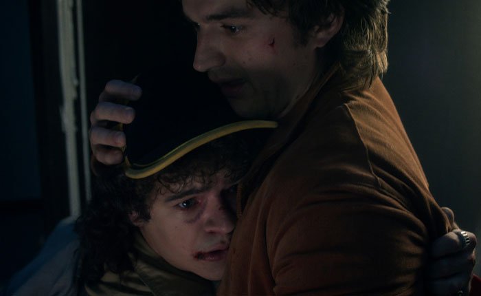 Two Stranger Things 5 characters in an emotional embrace, highlighting the show's comically bad penultimate episode reaction.