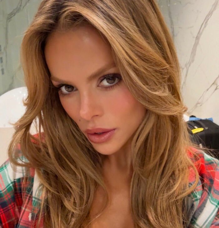 Brooks Nader close-up selfie with styled hair, wearing a plaid shirt, highlighting her fashion in Aspen.
