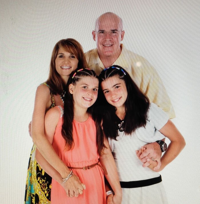 Family portrait of four smiling members in a bright setting, related to sorority girl tragic Christmas Eve accident news.