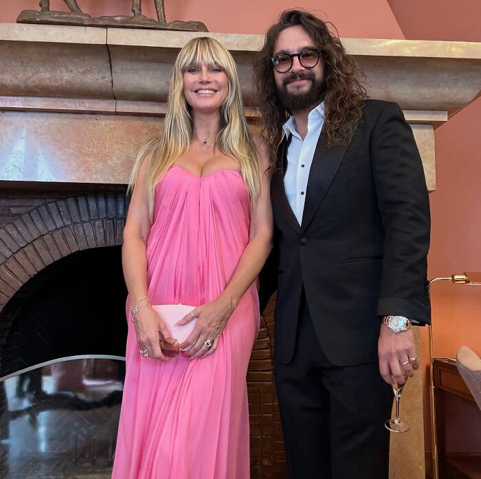 Heidi Klum and Tom Kaulitz posing indoors, dressed elegantly during their St Barths getaway.