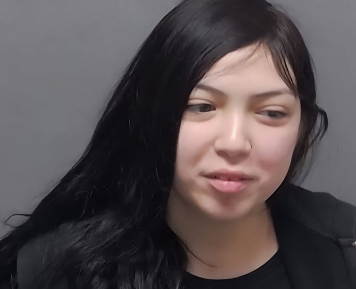 Teen with long dark hair and black jacket, involved in a harsh lesson by judge after pepper-spraying tourists on boat.