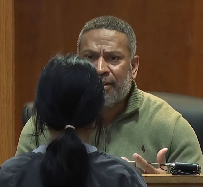 Judge speaking seriously to a teen in court during a harsh lesson after pepper-spraying tourists on a boat incident