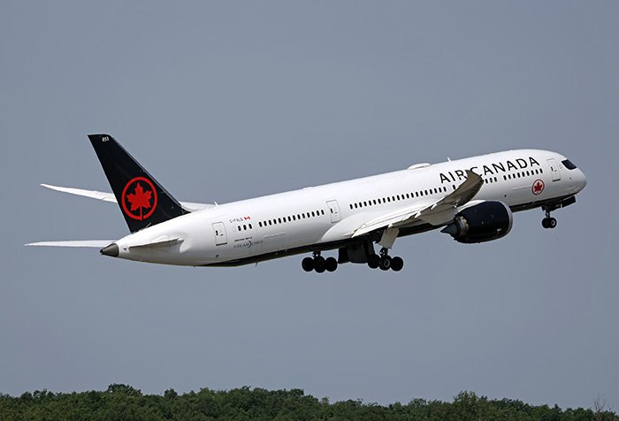 Air Canada airplane taking off against a clear sky, representing passenger complaints about airline meals.