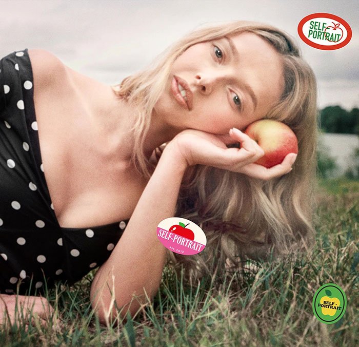 Apple Martin poses outdoors holding an apple, promoting Self-Portrait modeling campaign in a polka dot dress.