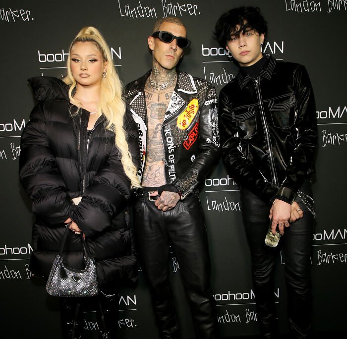 Kourtney Kardashian and Travis Barker posing at an event, facing backlash over an intimate gift to his daughter.