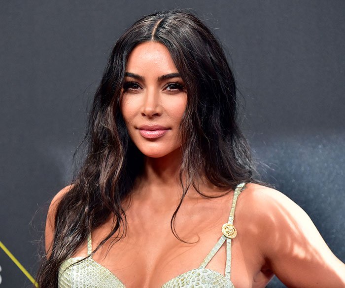 Kim Kardashian attending an event, highlighting her struggle to accept low brain activity after a medical scan.